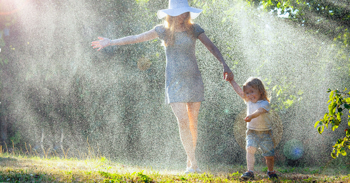 A happy mother and her child playing in the mist